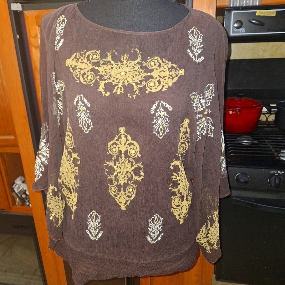 A Karen Kane 100% Silk Top With Tank In A Small. It has gold and silver designs.